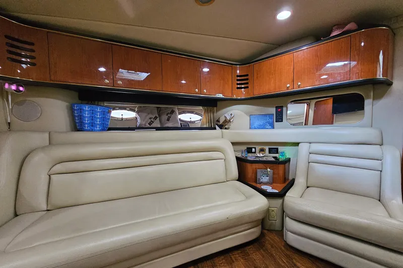 Slide: The Image of Luxurious interior of a 1999 Sea Ray 460 Sundancer yacht with leather seating and wooden cabinets. - 25