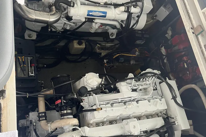 Slide: The Image of Engine compartment of a 1999 Sea Ray 460 Sundancer with visible tools and components. - 29