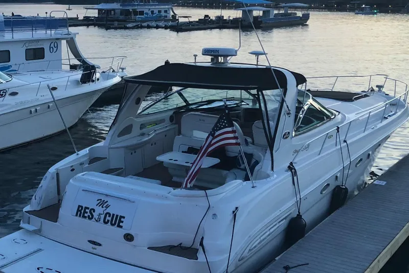 Slide: The Image of 1999 Sea Ray 460 Sundancer interior with seating and table under canopy. - 5