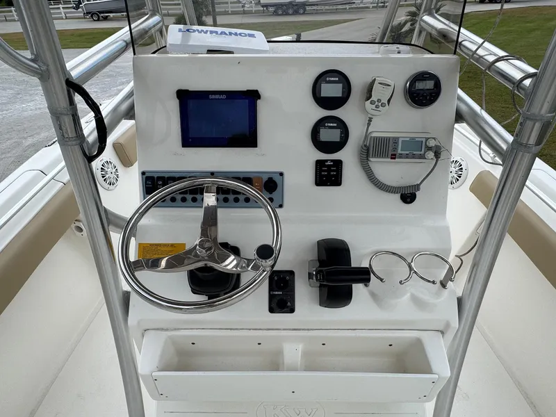 Slide: The Image of 2019 Key West 219 FS boat console with steering wheel, gauges, and navigation equipment. - 11