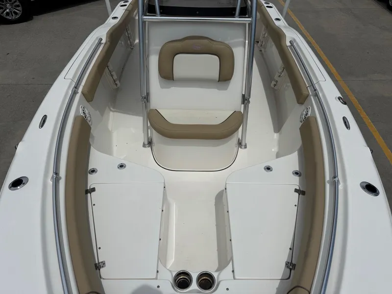Slide: The Image of 2019 Key West 219 FS boat interior with beige seating and white deck. - 15
