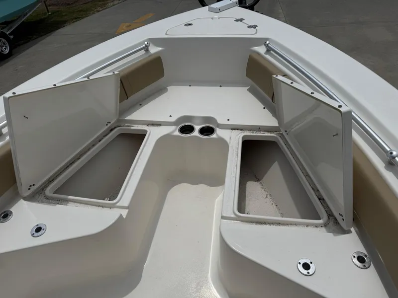 Slide: The Image of 2019 Key West 219 FS boat with open storage compartments on deck. - 16