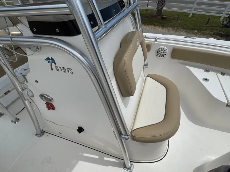 Slide: The Image of 2019 Key West 219 FS boat interior with tan seating and stainless steel railings. - 17