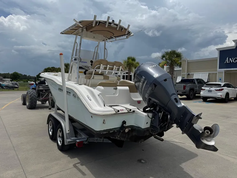 Slide: The Image of 2019 Key West 219 FS boat on trailer with Yamaha outboard motor, parked outdoors. - 3