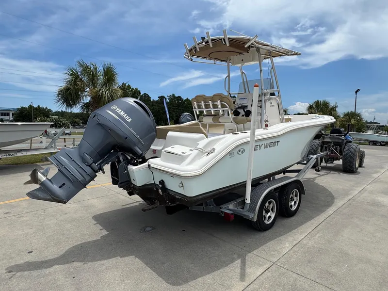 Slide: The Image of 2019 Key West 219 FS boat on trailer with Yamaha outboard motor, parked outdoors. - 5