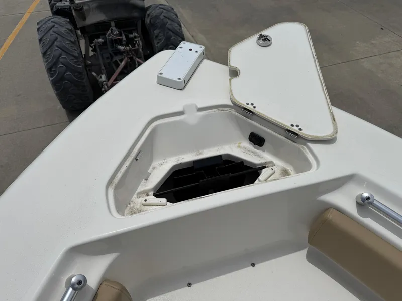 Slide: The Image of Open storage compartment on a 2019 Key West 219 FS boat, with visible interior details. - 7
