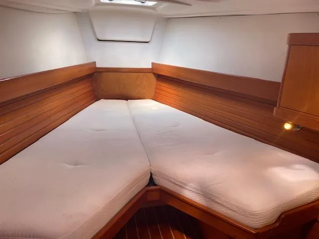 Slide: The Image of Cozy cabin interior of 2004 Wauquiez Centurion 40s sailboat with wooden accents and white cushions. - 13