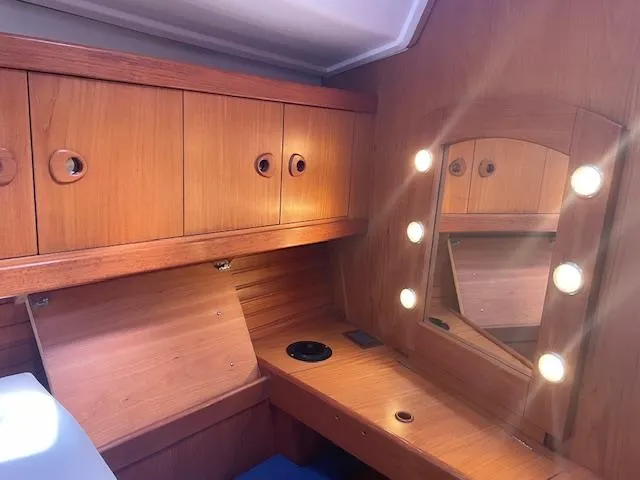 Slide: The Image of Interior of 2004 Wauquiez Centurion 40s yacht with wooden cabinets and mirror. - 14