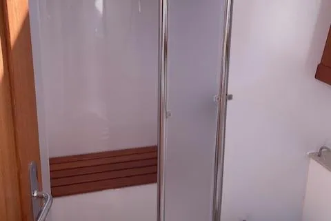 Slide: The Image of 2004 Wauquiez Centurion 40s yacht bathroom with shower and wooden bench. - 17