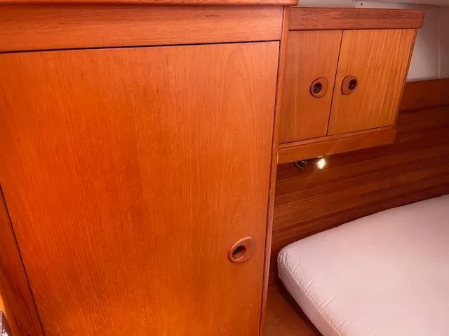 Slide: The Image of Interior cabin of 2004 Wauquiez Centurion 40s with wooden cabinetry and bed. - 18
