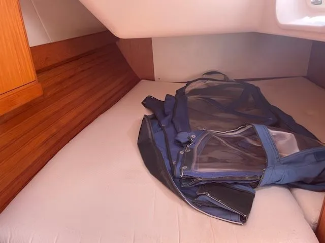 Slide: The Image of Cozy cabin interior of 2004 Wauquiez Centurion 40s with a blue bag on the bed. - 19