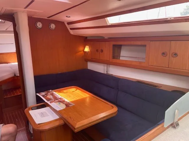 Slide: The Image of Interior of 2004 Wauquiez Centurion 40s yacht with cozy seating and wooden table. - 2