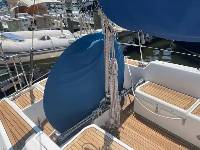 Slide: The Image of 2004 Wauquiez Centurion 40s sailboat cockpit with blue cover and wooden seating. - 20