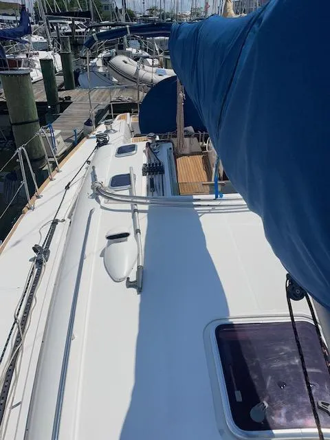 Slide: The Image of 2004 Wauquiez Centurion 40s sailboat deck with blue sail cover at marina. - 22