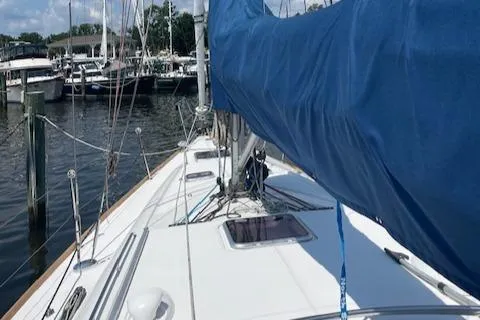 Slide: The Image of 2004 Wauquiez Centurion 40s sailboat docked at a marina, blue sail cover visible. - 23