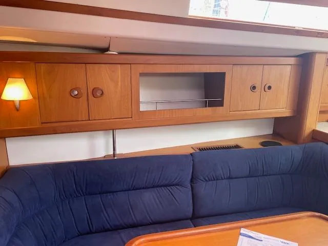 Slide: The Image of Interior of 2004 Wauquiez Centurion 40s yacht with blue seating and wooden cabinets. - 3