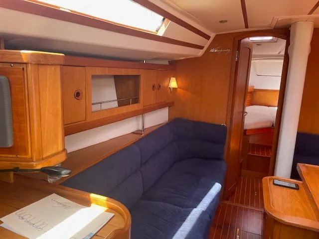 Slide: The Image of Interior of 2004 Wauquiez Centurion 40s sailboat with wooden finish and blue seating. - 4