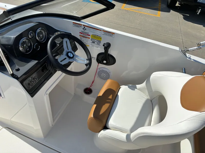 Slide: The Image of 2021 Bayliner VR4 Bowrider OB cockpit with steering wheel and cushioned seat. - 10