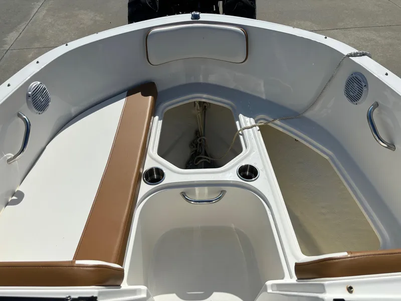 Slide: The Image of 2021 Bayliner VR4 Bowrider OB interior with brown seating and cup holders. - 12