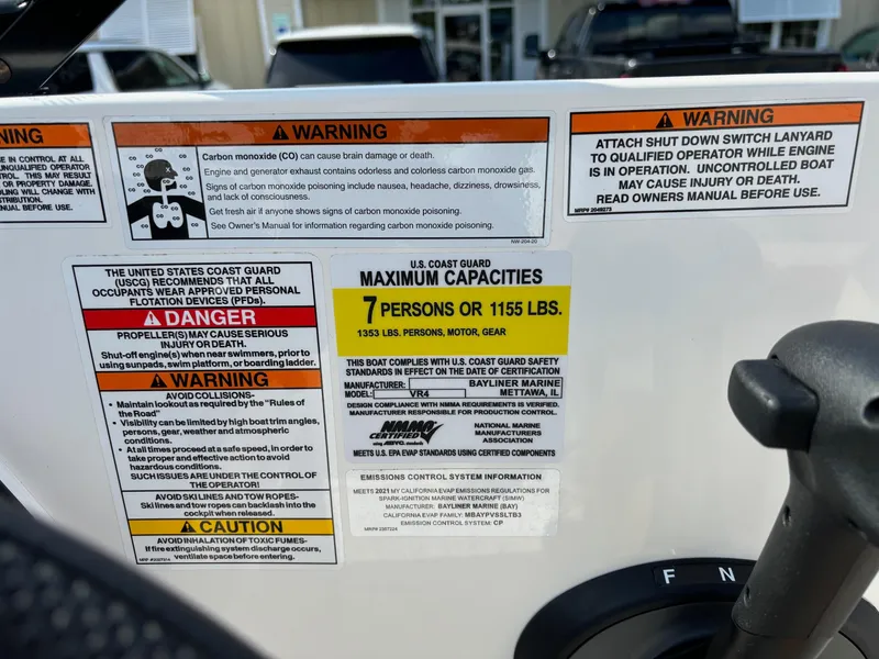 Slide: The Image of Warning labels on a 2021 Bayliner VR4 Bowrider OB boat, detailing safety and capacity information. - 13