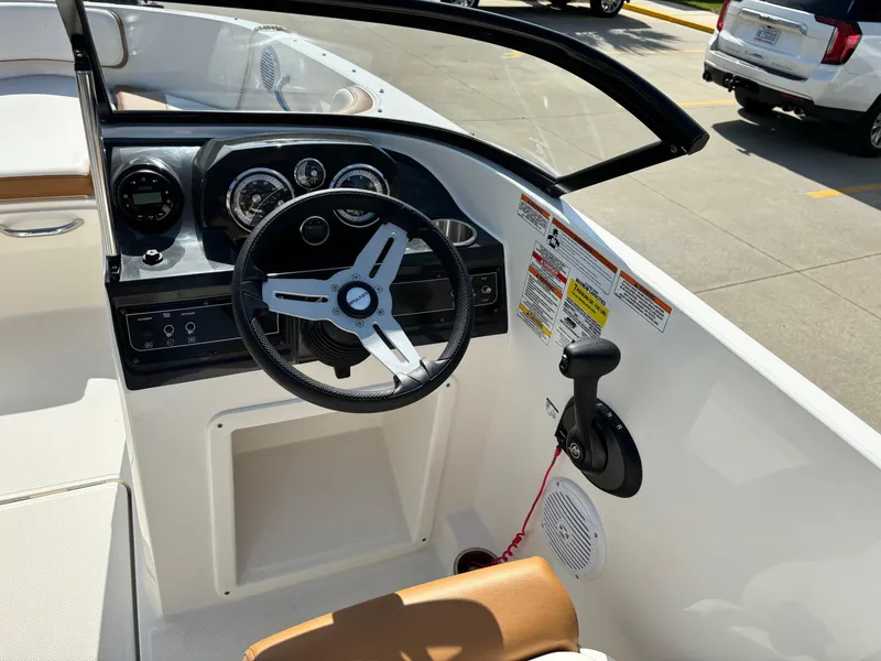 Slide: The Image of 2021 Bayliner VR4 Bowrider OB dashboard with steering wheel and controls in sunlight. - 5
