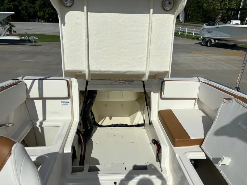 Slide: The Image of 2021 Bayliner VR4 Bowrider OB interior with open engine compartment, showcasing seating and storage. - 6