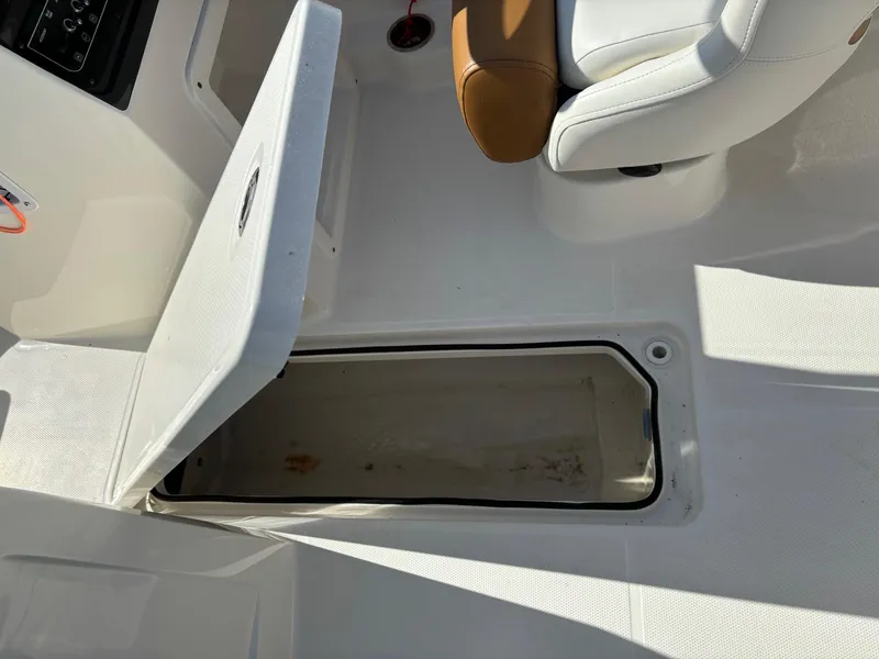 Slide: The Image of 2021 Bayliner VR4 Bowrider OB interior storage compartment with open hatch and seating. - 8