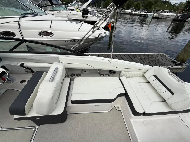 Slide: The Image of 2022 Regal LX2 boat interior with white seating, docked at marina. - 11