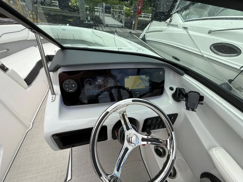 Slide: The Image of 2022 Regal LX2 boat dashboard with steering wheel and navigation display. - 20