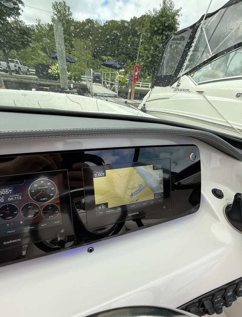 Slide: The Image of 2022 Regal LX2 boat dashboard with Garmin navigation system and speed gauges. - 23