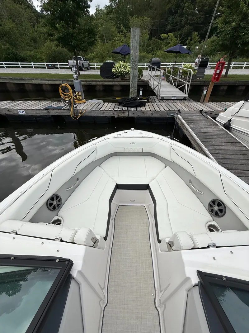 Slide: The Image of 2022 Regal LX2 boat interior at dock, featuring spacious seating and modern design. - 25
