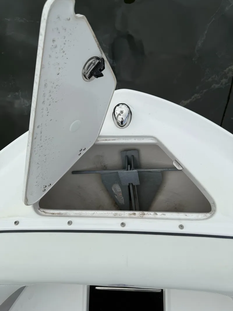 Slide: The Image of Open anchor compartment on 2022 Regal LX2 boat, showing anchor storage. - 30