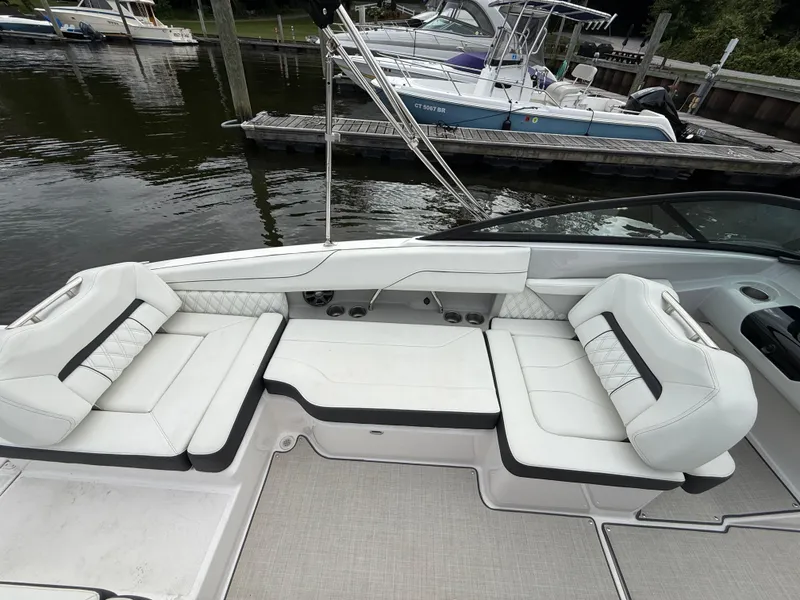 Slide: The Image of 2022 Regal LX2 boat interior with white seating, docked at marina. - 9