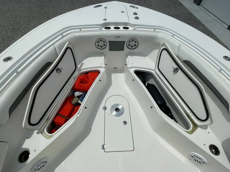 Slide: The Image of 2020 Tidewater 280 CC Adventure Custom boat with open storage compartments and safety gear. - 12