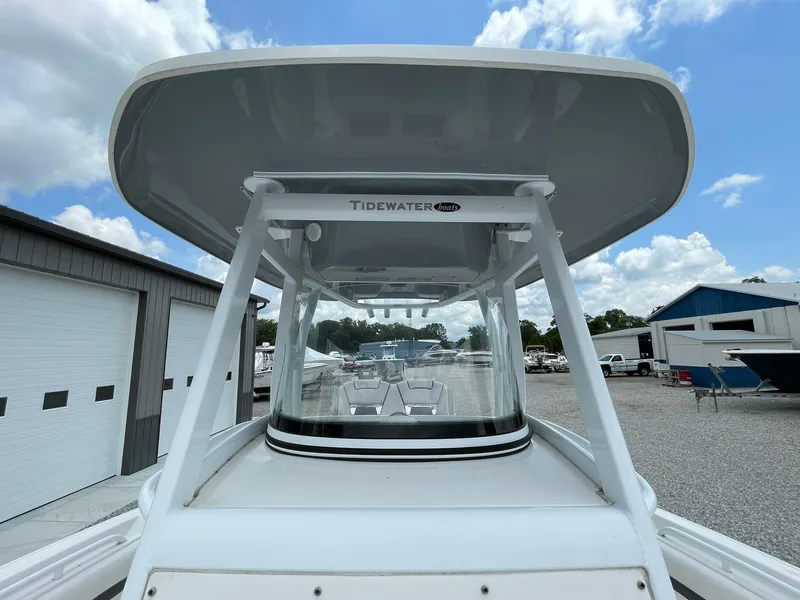 Slide: The Image of 2020 Tidewater 280 CC Adventure Custom boat, docked under a cloudy sky. - 15