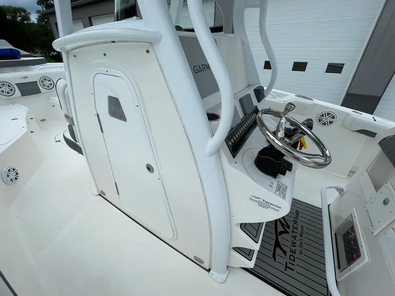 Slide: The Image of 2020 Tidewater 280 CC Adventure Custom boat cockpit with steering wheel and control panel. - 18
