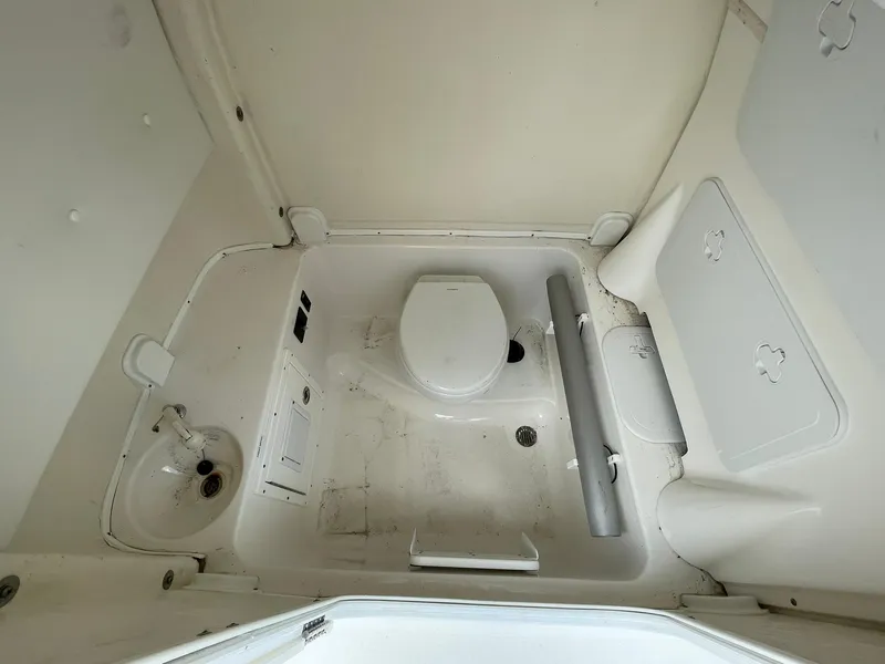 Slide: The Image of 2020 Tidewater 280 CC Adventure Custom boat bathroom interior with toilet and sink. - 19