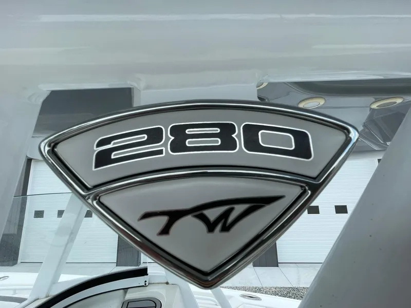 Slide: The Image of Tidewater 280 CC Adventure Custom 2020 emblem on a sleek boat exterior. - 2