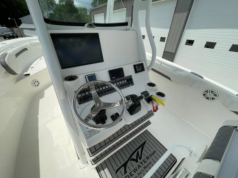 Slide: The Image of 2020 Tidewater 280 CC Adventure Custom boat helm with steering wheel and electronic controls. - 25