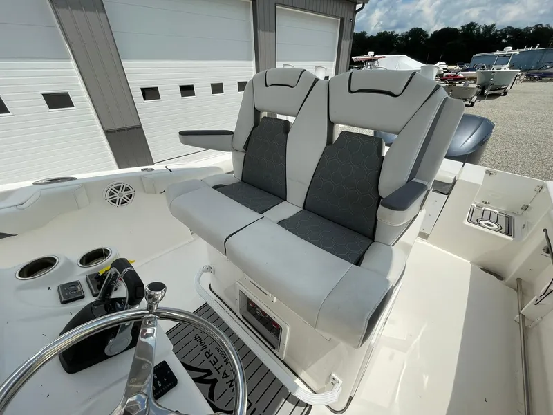 Slide: The Image of 2020 Tidewater 280 CC Adventure Custom boat with dual captain's chairs and steering wheel. - 28