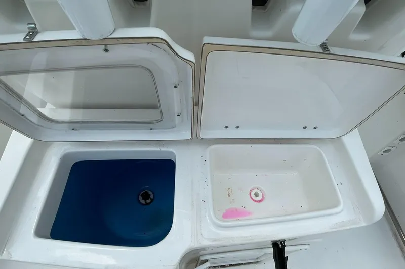 Slide: The Image of Tidewater 280 CC Adventure Custom 2020 boat storage compartments, open with visible interior. - 33