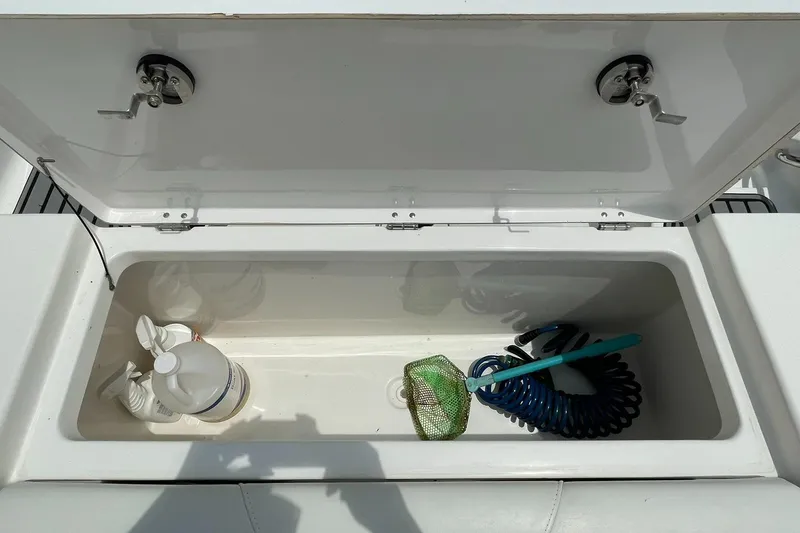 Slide: The Image of Open storage compartment on 2020 Tidewater 280 CC Adventure Custom boat with cleaning supplies. - 41