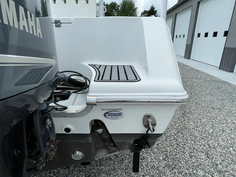 Slide: The Image of 2020 Tidewater 280 CC Adventure Custom boat stern with Yamaha engine, parked on gravel. - 47