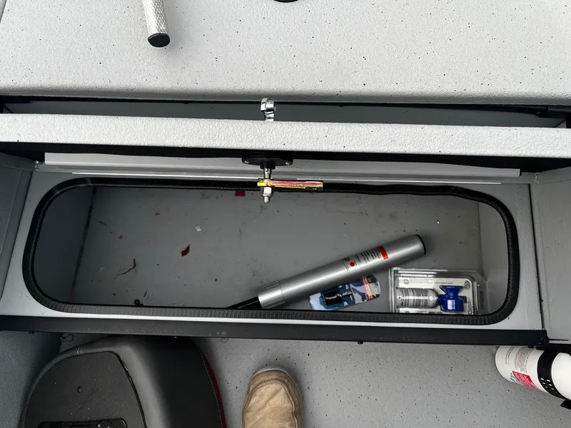 Slide: The Image of Open storage compartment in 2021 Ranger RT178 boat with tools and accessories. - 11