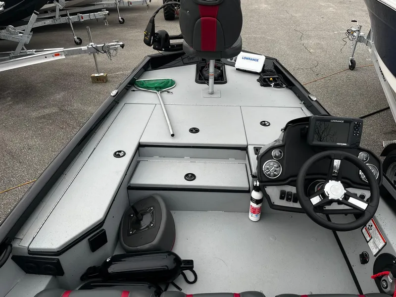 Slide: The Image of 2021 Ranger RT178 boat interior with steering console, fishing gear, and Lowrance electronics. - 12