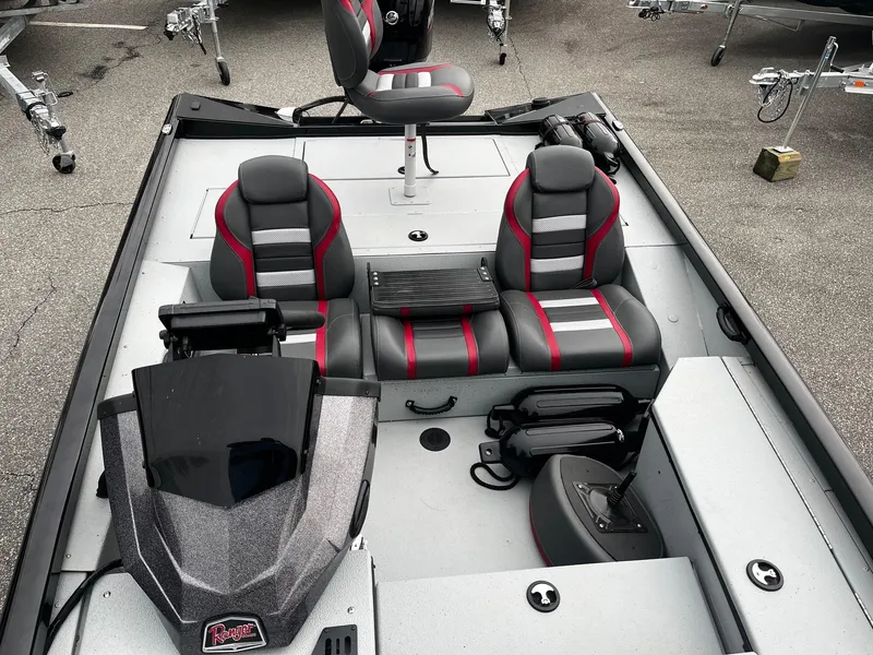 Slide: The Image of 2021 Ranger RT178 boat interior with gray and red seating, steering console, and storage compartments. - 13
