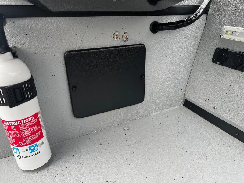 Slide: The Image of 2021 Ranger RT178 boat interior with fire extinguisher and control panel. - 14