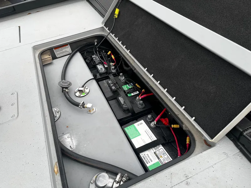 Slide: The Image of 2021 Ranger RT178 boat battery compartment with multiple batteries and wiring. - 17