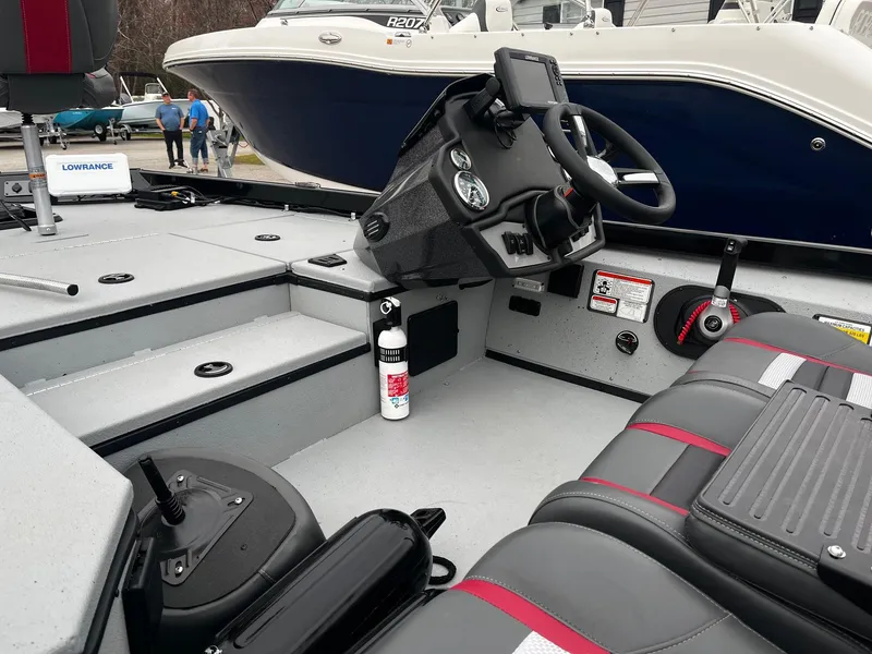 Slide: The Image of 2021 Ranger RT178 boat interior with steering console and seating, featuring Lowrance electronics. - 18
