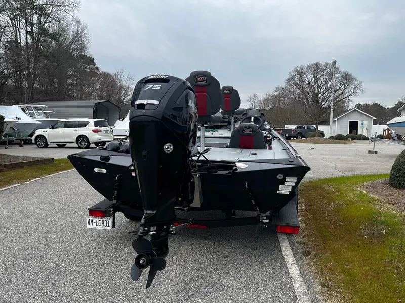 Slide: The Image of 2021 Ranger RT178 boat with Mercury 75 engine parked outdoors. - 2